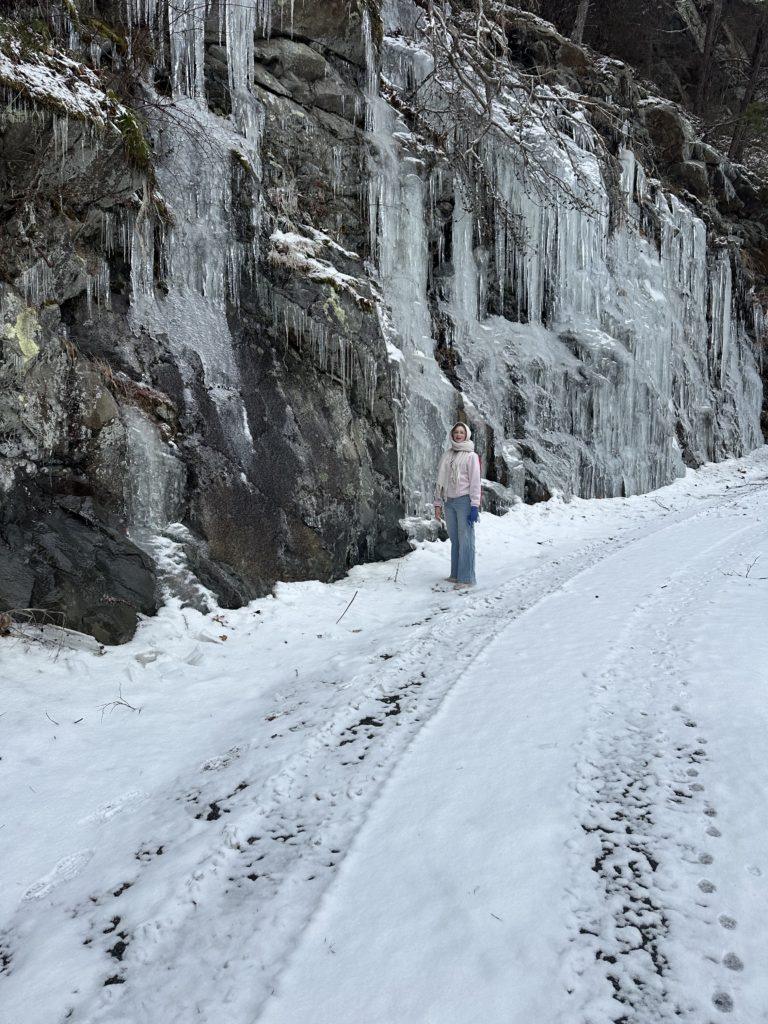 Girl staring at a frozen rock wall near Watauga Dam.