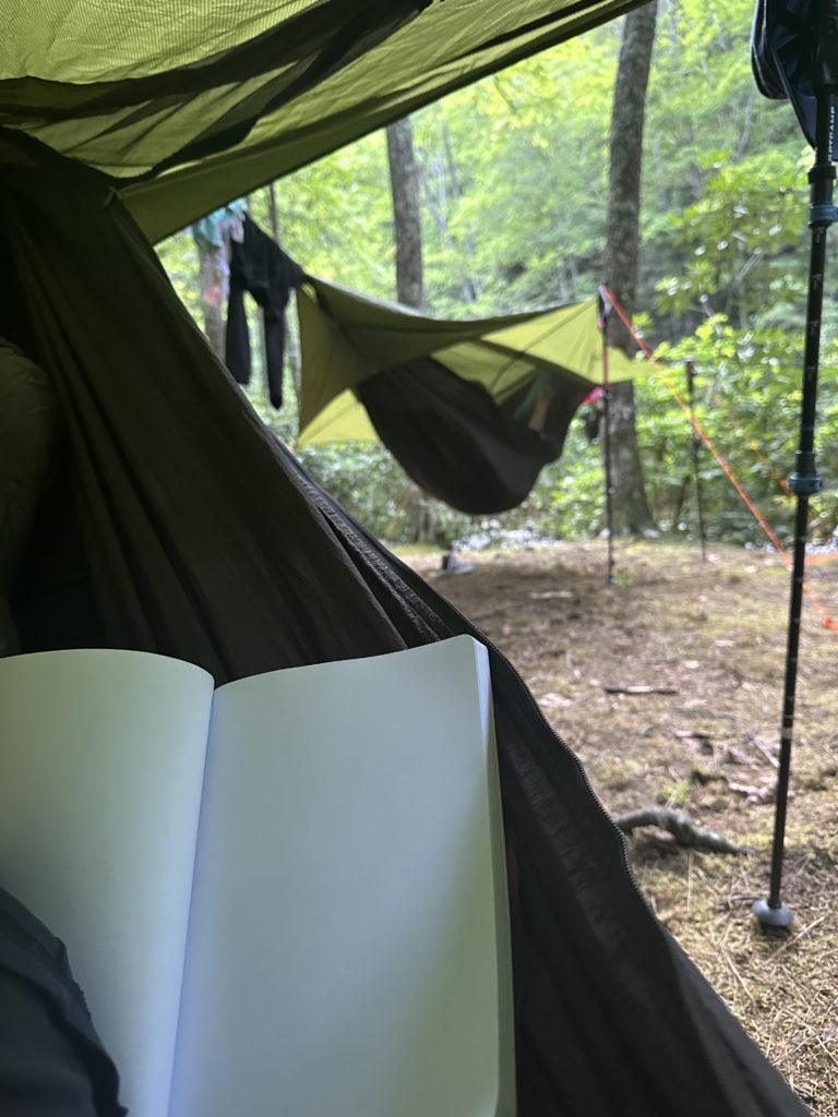Journaling in a hammock on a backpacking trip.