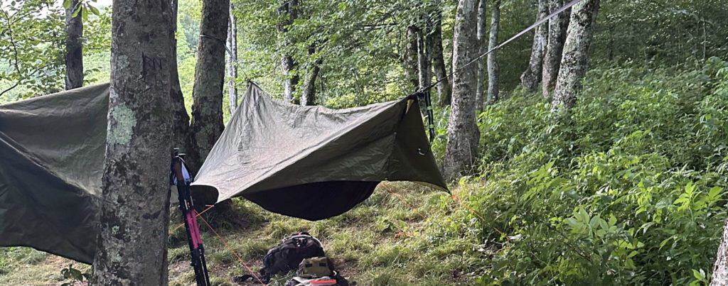 Eremos backcountry camp setup. 2 hammocks between trees.