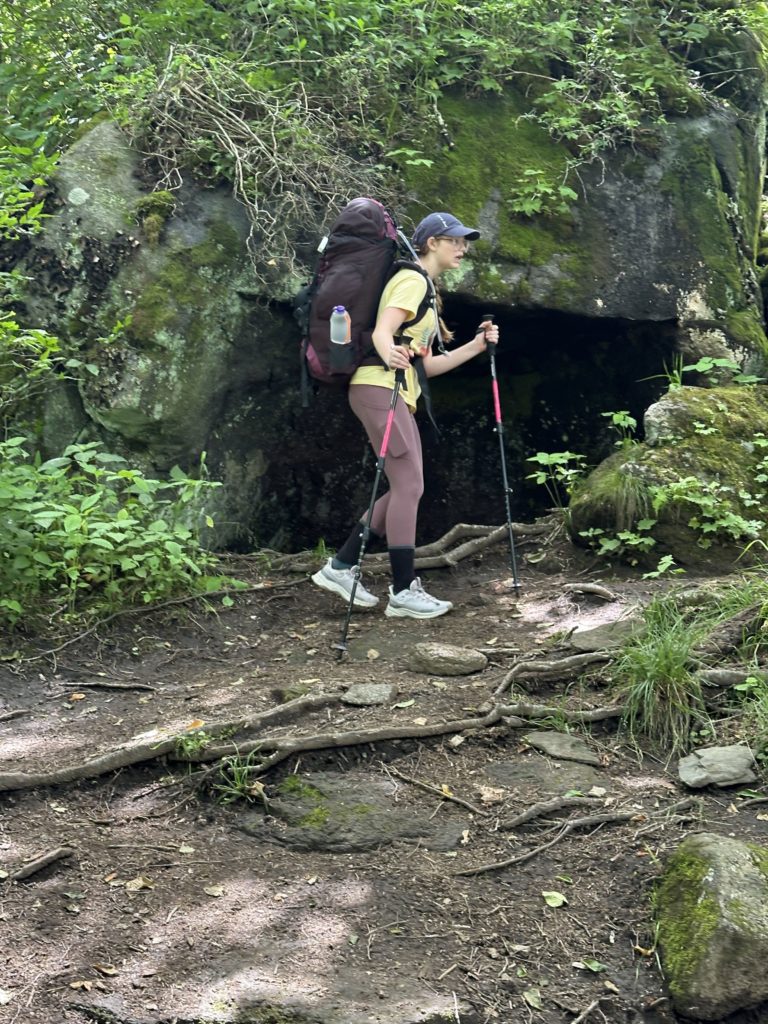 Young hiker finding her way along the path on an Eremos Backpacking Experience.